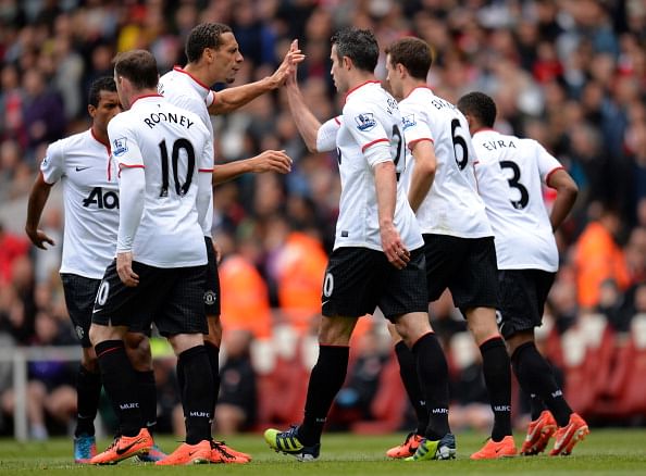 Rio Ferdinand of Manchester United congratulates Robin van Persie of Manchester United after he scored from the penalty spot to make it 1-1 during the Barclays Premier League match between Arsenal and Manchester United at Emirates Stadium on April 28, 2013 in London, England. (Photo by Shaun Botterill/Getty Images)